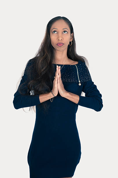 istock Beautiful woman doing different expressions in different sets of clothes: prayer 636628412