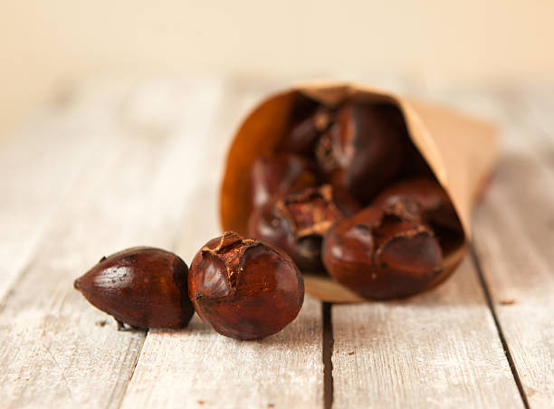 istock Roasted chestnuts served in paper bag 636628806