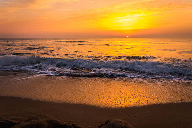 istock Golden sunrise sunset over the sea ocean waves 636630042