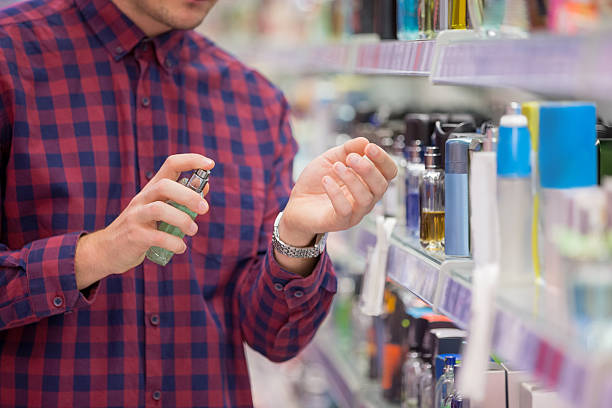 Unrecognisable man choosing cosmetics in local supermarket