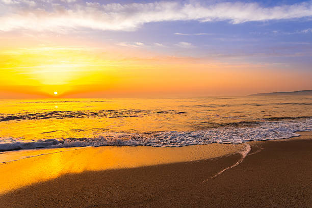 istock Golden sunrise sunset over the sea ocean waves 636630564