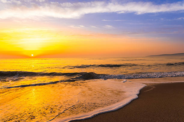istock Golden sunrise sunset over the sea ocean waves 636630624