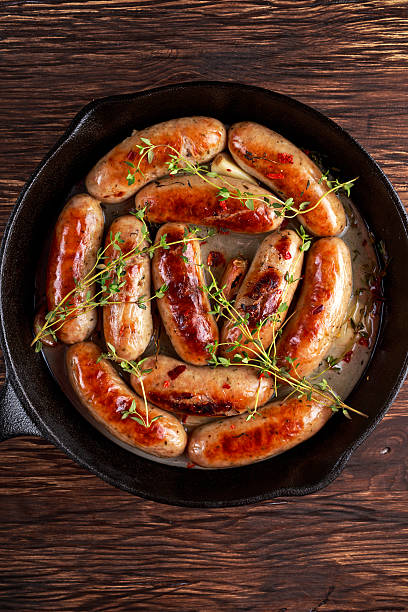 istock Home-made Pork Sausages in rustic pan with thyme 636632784
