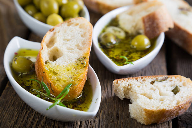 el pan bañado en aceite de oliva con hierbas y especias - aceite de oliva fotografías e imágenes de stock