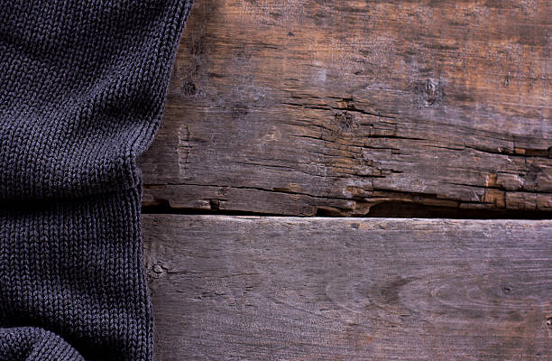 istock knitted plaid, sweater on old wooden boards 636634744