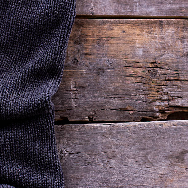 istock knitted plaid, sweater on old wooden boards 636634774