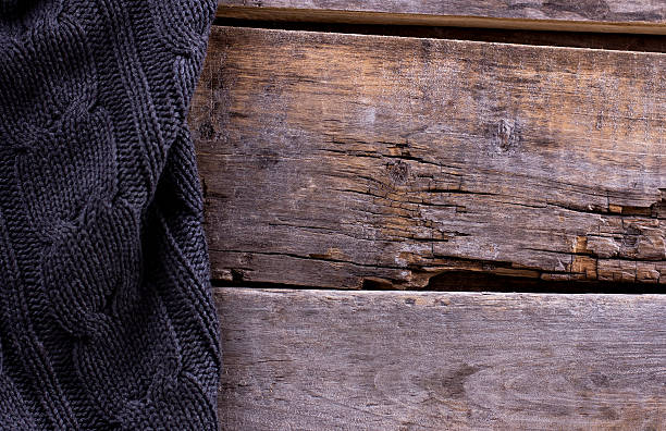 istock knitted plaid, sweater on old wooden boards 636634910