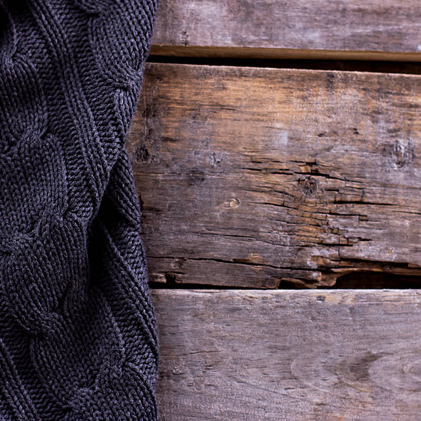 istock knitted plaid, sweater on old wooden boards 636634942