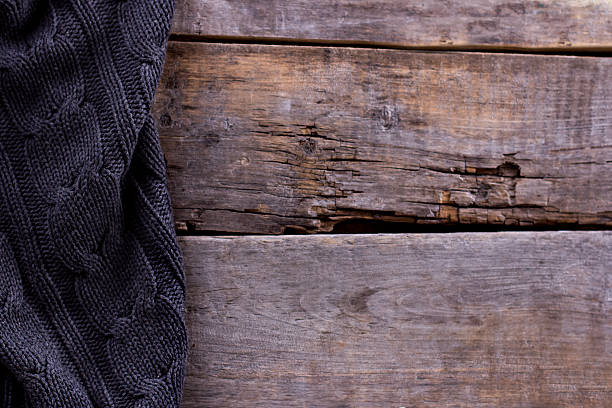 istock knitted plaid, sweater on old wooden boards 636634982