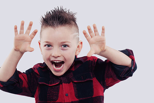istock Portrait playful boy showing hands 636635072