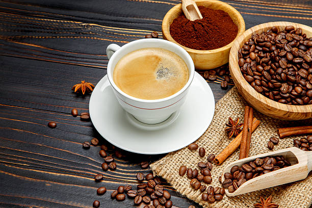 istock mug with roasted coffee beans on wooden background 636635342