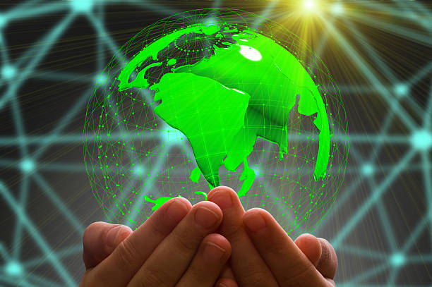 istock kid's hand holding globe in dark background 636635832