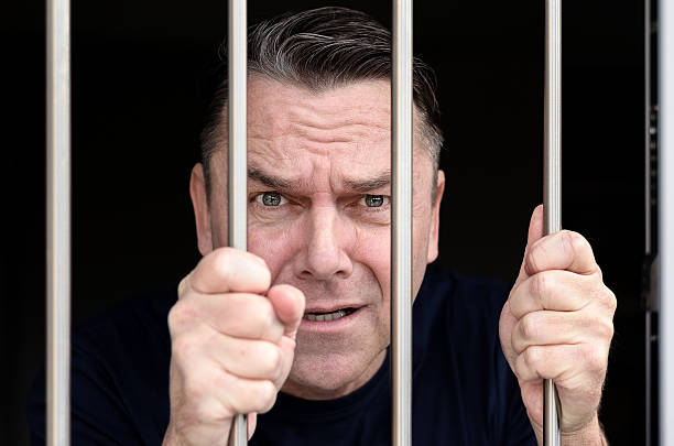 istock Middle aged blue eyed man incarcerated 636635974