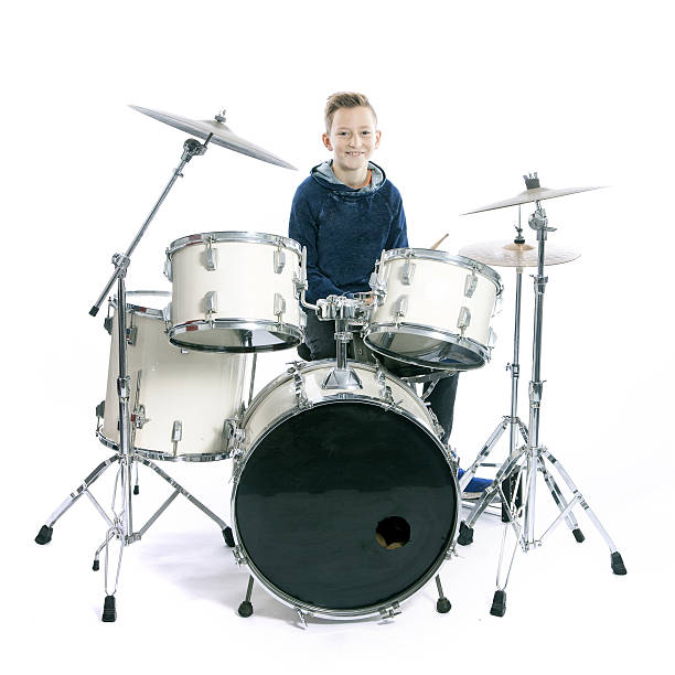 istock teenage boy behind drum kit in studio 636637984