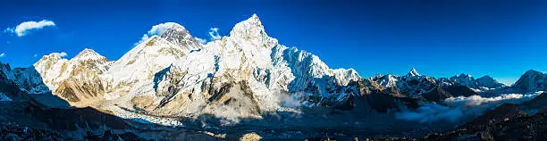 The iconic pyramid summit of Mt. Everest (8848m) and the dramatic snow capped ridge of Nuptse (7861m) towering above the Khumbu icefall and Everest base camp on the glacier below with panoramic views down the valley to Ama Dablam 6812m and the peaks of the Sagarmatha National Park, Nepal.