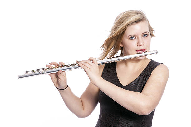 istock young blond woman plays the flute against white background 636638504
