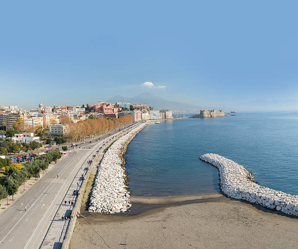 Naples, Italy - December 14, 2016: Aerial view of the seafront of Naples. On the left visible undefined people who walk on Caracciolo street. On background \