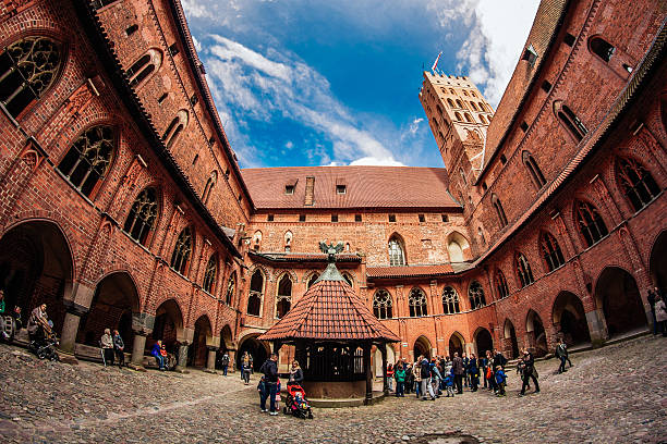 Malbork Castle Malbork, Poland – May 1, 2016: People having a tour around the Castle of the Teutonic Order in Malbork malbork photos stock pictures, royalty-free photos & images