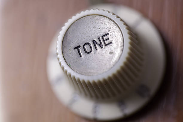 Vintage tone Focus on a retro tone dial from a vintage guitar. knurl stock pictures, royalty-free photos & images