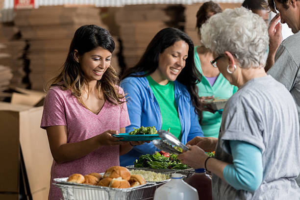 istock People receive healthy meals at soup kitchen 636644340
