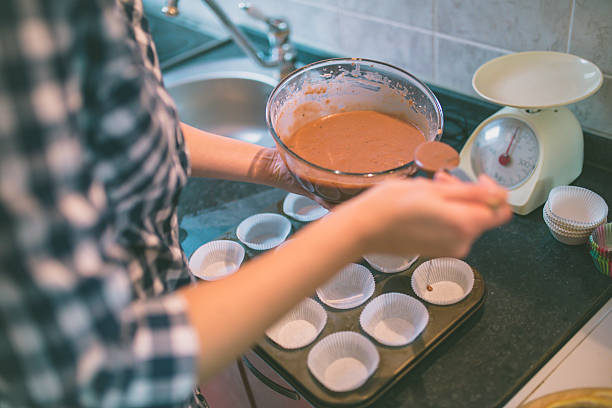 Woman making chocolate muffins.