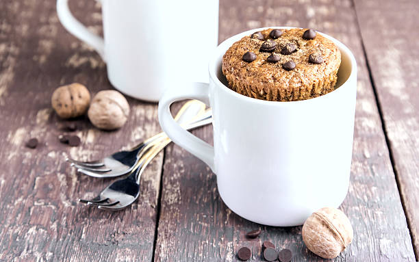 istock Chocolate muffins with chocolate drops served in white mugs 636646508