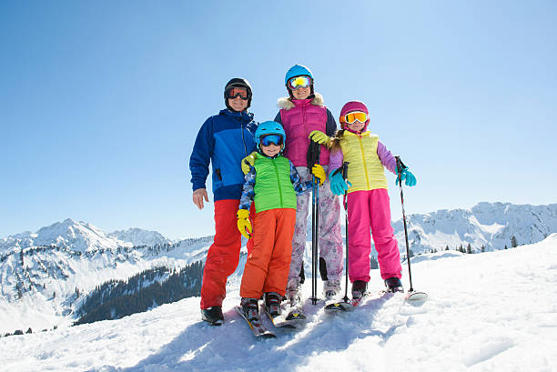 istock Happy family enjoying winter vacations in mountains . 636646880