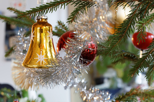 Christmas decorations like balls and christmas tinsel in the Christmas tree