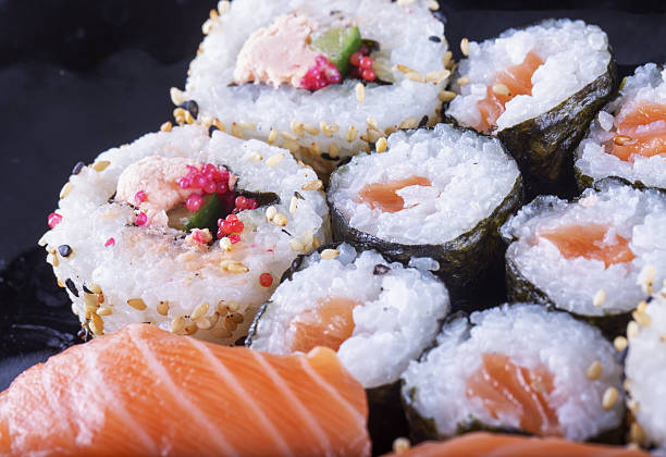istock Sushi of several types over black plate 636650288