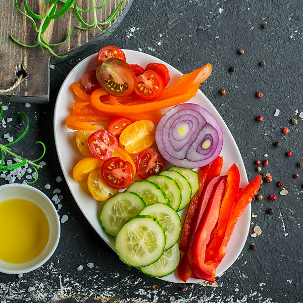 istock Ingredients for fresh vegetable salad tomatoes, cucumbers, sweet peppers on 636650446