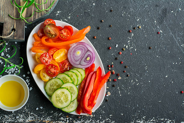 istock Ingredients for fresh vegetable salad tomatoes, cucumbers, sweet peppers on 636650930