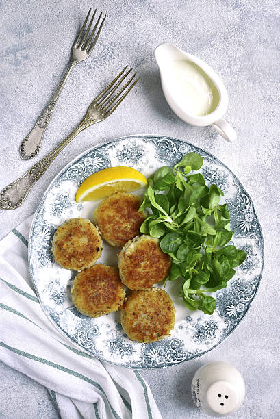 istock Fish cutlets with cream sauce on a vintage plate.Top view. 636651052