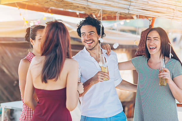 istock Young people drinking beer in the summer 636653472