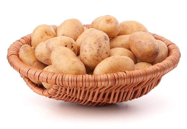 istock Potato tuber  in wicker basket isolated on white background 636654534