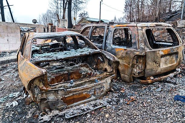 istock Burned cars and home after forest fires 636656946
