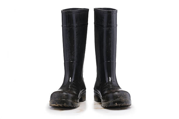 istock Wet dirty Mud boots isolated on pure white background 636656962
