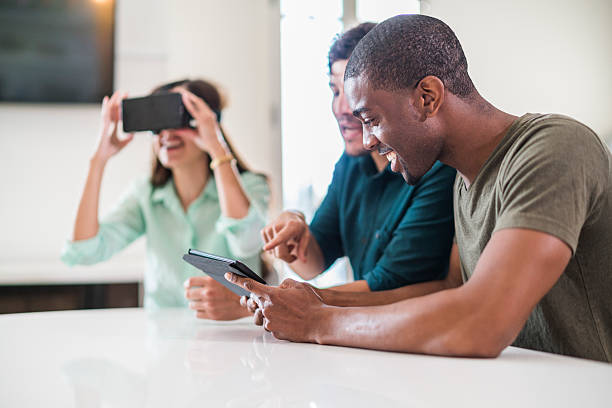 istock Three friends, white, black and latino, exploring virtual reality 636658202