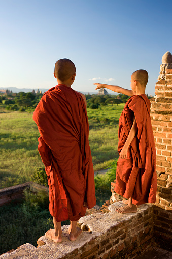 Two young Buddhist monks looking at a view in Bagan, Myanmar (Burma)