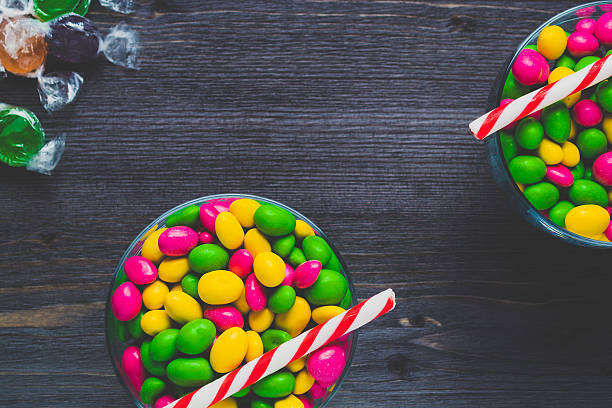istock Colorful candies on a dark wooden background 636662302