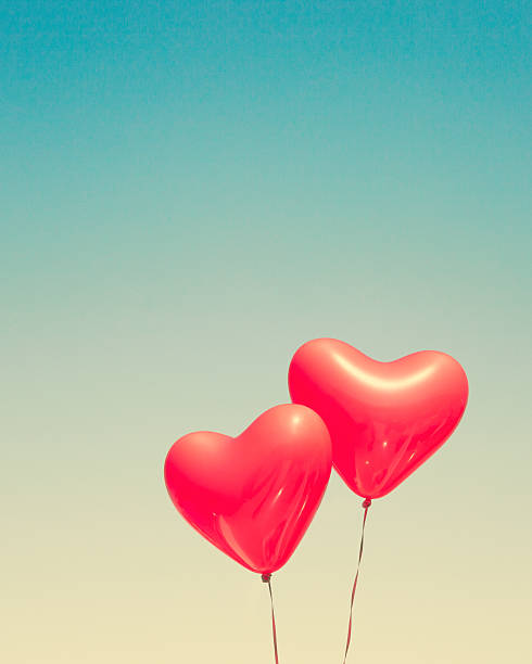 istock Two red heart shaped balloons 636662388