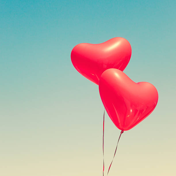 istock Two red heart shaped balloons 636662772