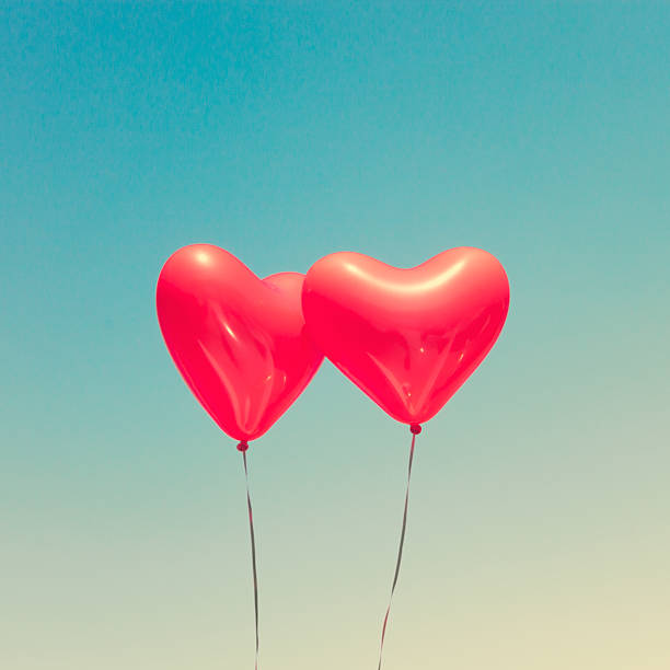 istock Two red heart shaped balloons 636662826