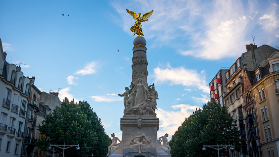 Sube fountain in city center of Reims with golden angel, autumn France