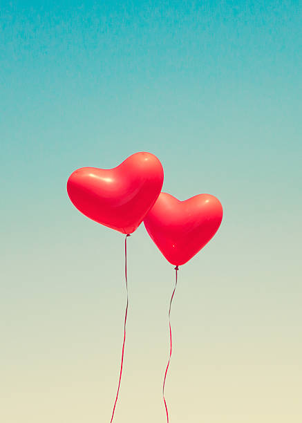 istock Two red heart shaped balloons 636663458