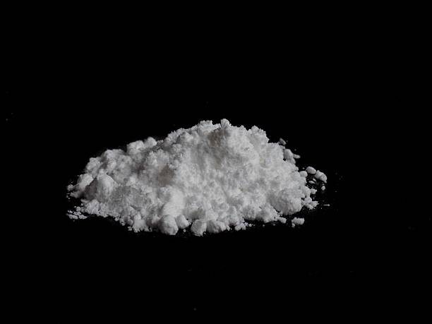 istock Cocaine drug powder pile on black background 636664636