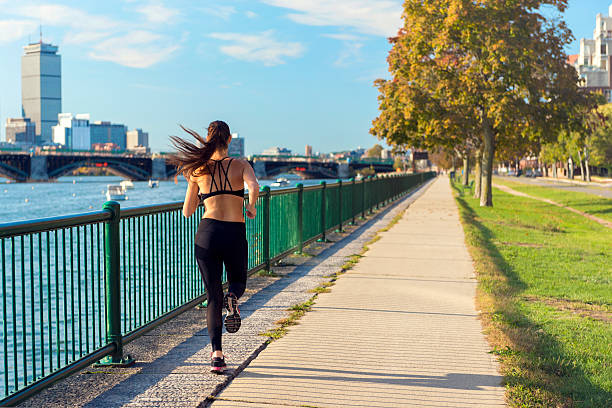 Runner in front of Boston's Skyline Runner in front of Boston's (USA) skyline in the morning. You can see the Longfellow Bridge crossing Charles river as well as some skyscrapers like the Prudential Tower. charles river stock pictures, royalty-free photos & images