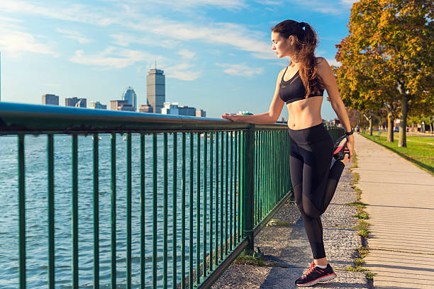 istock Female Runner Stretching While Enjoying the View in Boston, USA 636666018