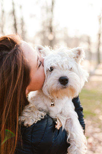 Girl kissing her cute dog