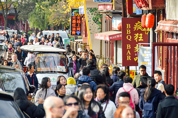 Beijing, China - November 19, 2016: Typical crowded hutong street in Beijing, China. Photo taken during the day and contains many people.
