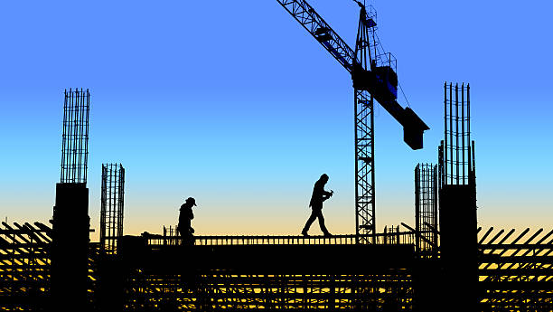 istock silhouette of worker in construction site 636669436